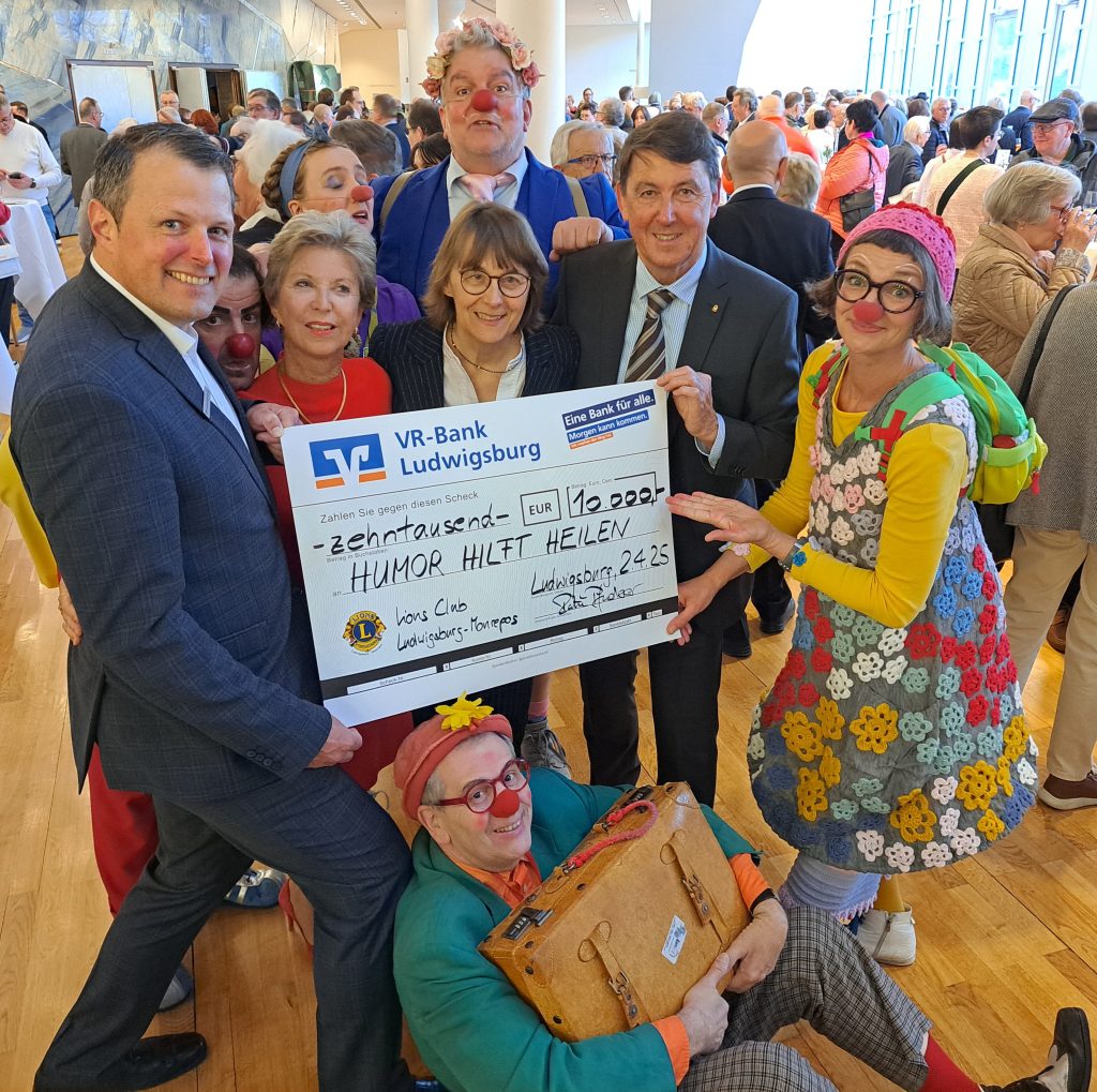Maria Bley, Stiftungleitung HUMOR HILFT HEILEN (Mitte), nimmt den Spendenscheck von Andreas Büdenbender, Bereichsleiter Privatkunden Region Ludwigsburg, VR Bank Ludwigsburg und von Lions-Präsidentin Susanne Pfab-Groche (links) und Martin Pfuderer, 1. Vorsitzender des Fördervereins des Lions Club Ludwigsburg-Monrepos (rechts) für die Klinikclownvisiten im RKH Klinikum Ludwigsburg entgegen. Ein herzlicher Dank auch an unsere Klinikclowns, die am Abend auch im Einsatz waren!_Foto HHH